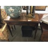 A mahogany fold over table.