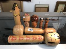 A quantity of Japanese wood ornaments including dolls.