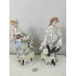A pair of 19th century shepherd and shepherdess figurines with sheep.