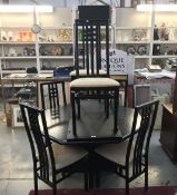 A black oak effect dining table and 6 chairs.