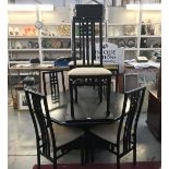 A black oak effect dining table and 6 chairs.