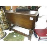 A dark oak coffee table with drop leaves.