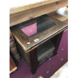 A darkwood stained coffee table with glass centre and drawer.