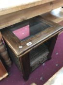 A darkwood stained coffee table with glass centre and drawer.
