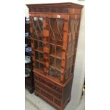 A wooden cabinet with astragal glazed doors.