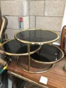 A 3 tier smoke glass coffee table.