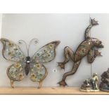 A butterfly and frog garden wall art.