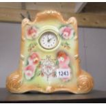 A pottery mantel clock with battery movement.