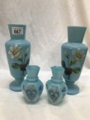 A pair of hand painted blue glass vases and a smaller pair.