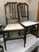 A pair of Edwardian mahogany hall chairs with string inlay.