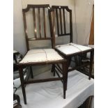 A pair of Edwardian mahogany hall chairs with string inlay.