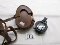A T.G & Co., 1044 Mk III military compass with original leather case.