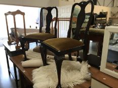 A pair of Edwardian dark wood dining chairs.