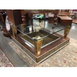 A large glass topped classical style coffee table.