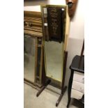 A brass framed cheval mirror on wooden stand,.