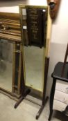 A brass framed cheval mirror on wooden stand,.