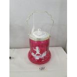 A Mary Gregory style cranberry glass biscuit barrel.