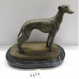 A bronze greyhound on a marble base.