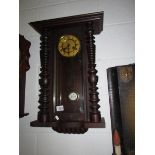 A mahogany wall clock.