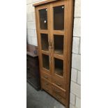 A 2 door 6 drawers wooden cabinet with glazed doors.