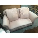 A pink fabric 2 seater drop end settee.