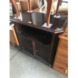 A dark wood stained cupboard.