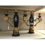 A pair of gilded pottery candelabra.