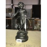 A French spelter figure of a girl with hoop.