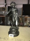A French spelter figure of a girl with hoop.