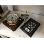 An Ingersoll quarts ship style wall clock, a brass ships anchor and knot display.