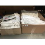 2 boxes of assorted linen including table cloths, tray cloths etc.