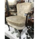 A 1930s fabric covered arm chair with Queen Anne legs.