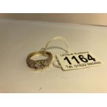 A 14ct gold ring set with 3 white stones, marked 585, Size T.