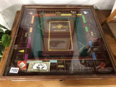 A fabulous collector's edition cased monopoly set with glass lid.