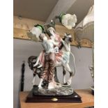 A superb figural table lamp with lovers and horse.