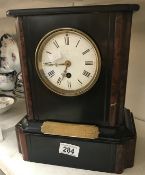 A black slate mantle clock.