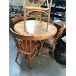 A pine centre pedestal dining table and 4 chairs.