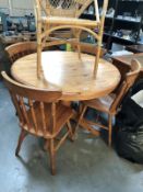 A pine centre pedestal dining table and 4 chairs.