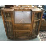 A carved 1930s/40s bureau with glazed side display cabinets.