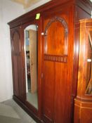 A mahogany wardrobe with mirrored door.