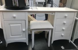 A white dressing table and stool.