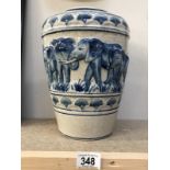A blue and white stoneware vase depicting elephants.