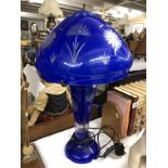 A blue overlaid glass table lamp.