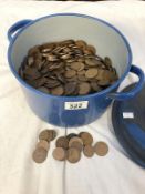 A heavy enamelled metal cooking pot full of coins, mostly pre-decimal pennies.