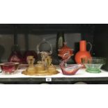 A shelf of art glass including amber glass dressing table set.