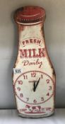 A metal milk bottle advertising sign wall clock.