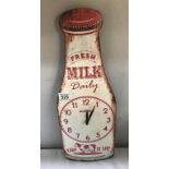 A metal milk bottle advertising sign wall clock.