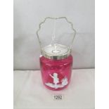 A Mary Gregory style cranberry glass biscuit barrel.