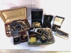 A mixed lot of costume jewellery and watches.