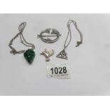 A malachite pendant, a Celtic pendant, both on silver chains, a bird pendant and a brooch.